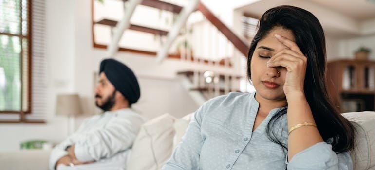 Couple sitting on the couch after having an argument.