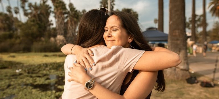 Two women hugging each other.