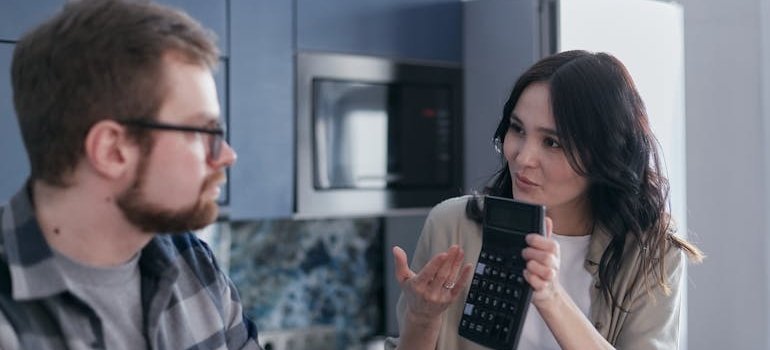 Woman showing a calculator to her partner.