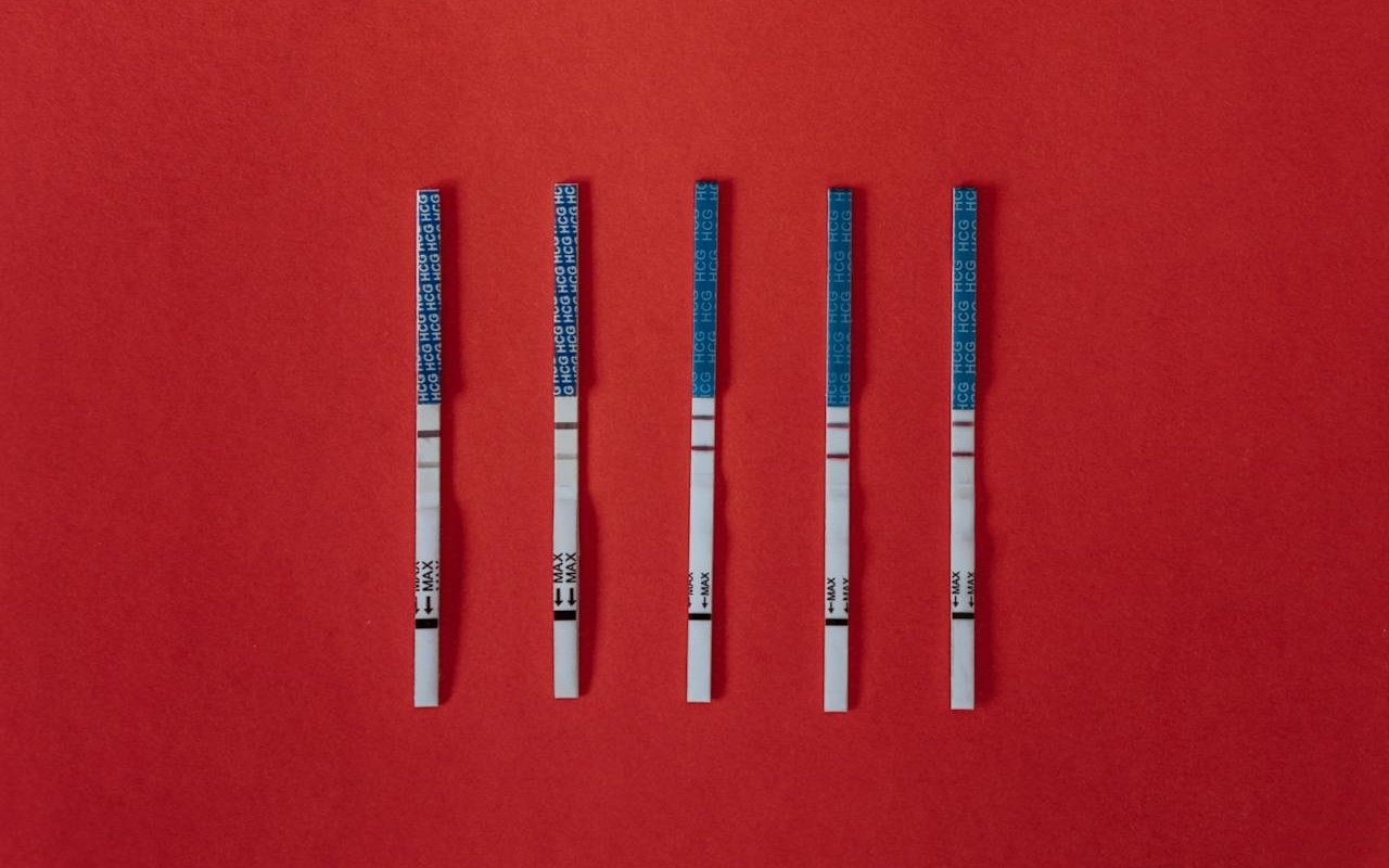 Fentanyl test strips on a red background.