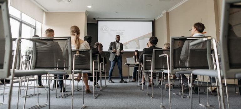 Man having a lecture about employment after rehab in front of a group of people.