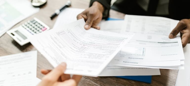 Man handing a patient the insurance papers.