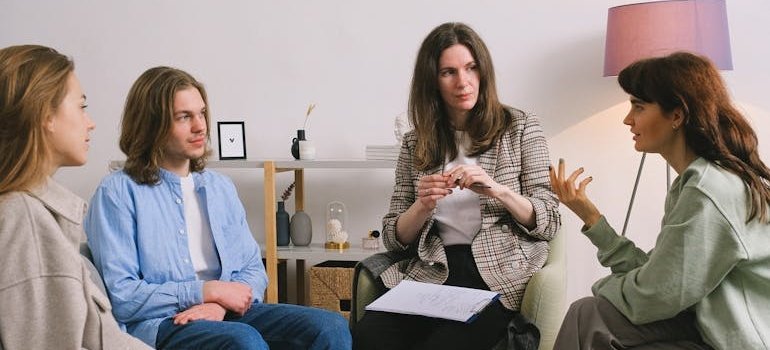 People in group of therapy talking about employment after rehab.