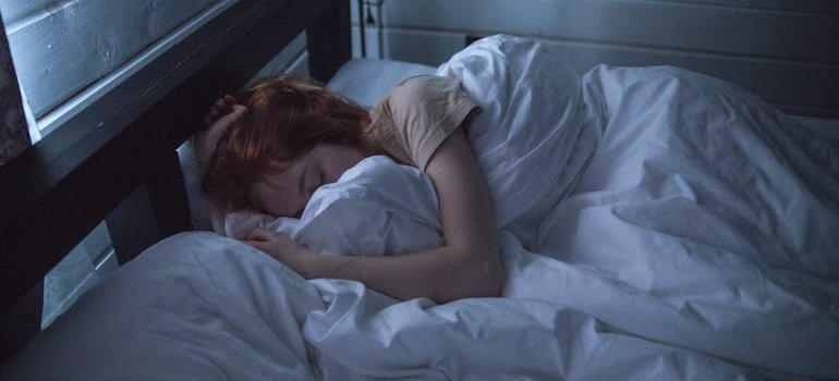 Woman hugging her blanket while sleeping.