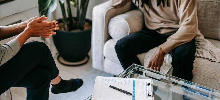 Therapist talking to a patient enrolling in rehab.