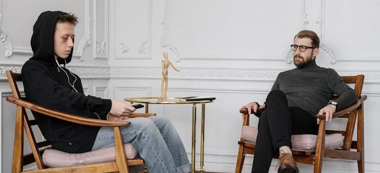 Young man talking about his issues with Christmas depression with a therapist.