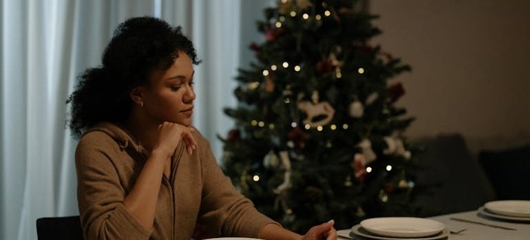 Sad woman looking at her plate during Christmas dinner.