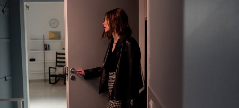 Woman opening the door to her apartment.