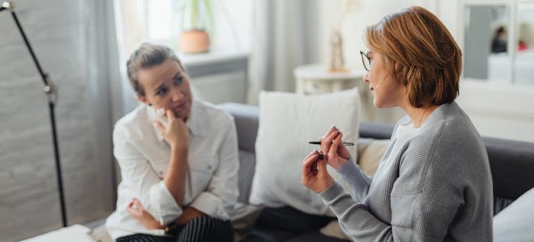 Therapist explaining grounding techniques to a grieving patient.