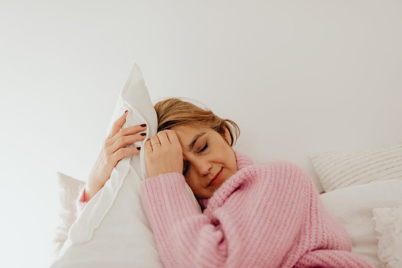 Woman hugging her pillow while going through Suboxone withdrawal.