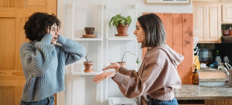 Two girls having an argument in their living room.