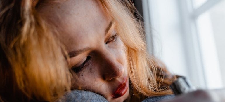 Crying woman looking out of the window.