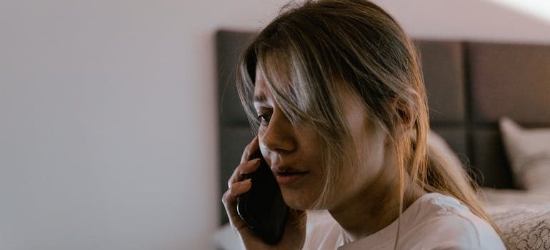 Scared woman calling emergency services.