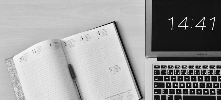 Planner next to a laptop clock.
