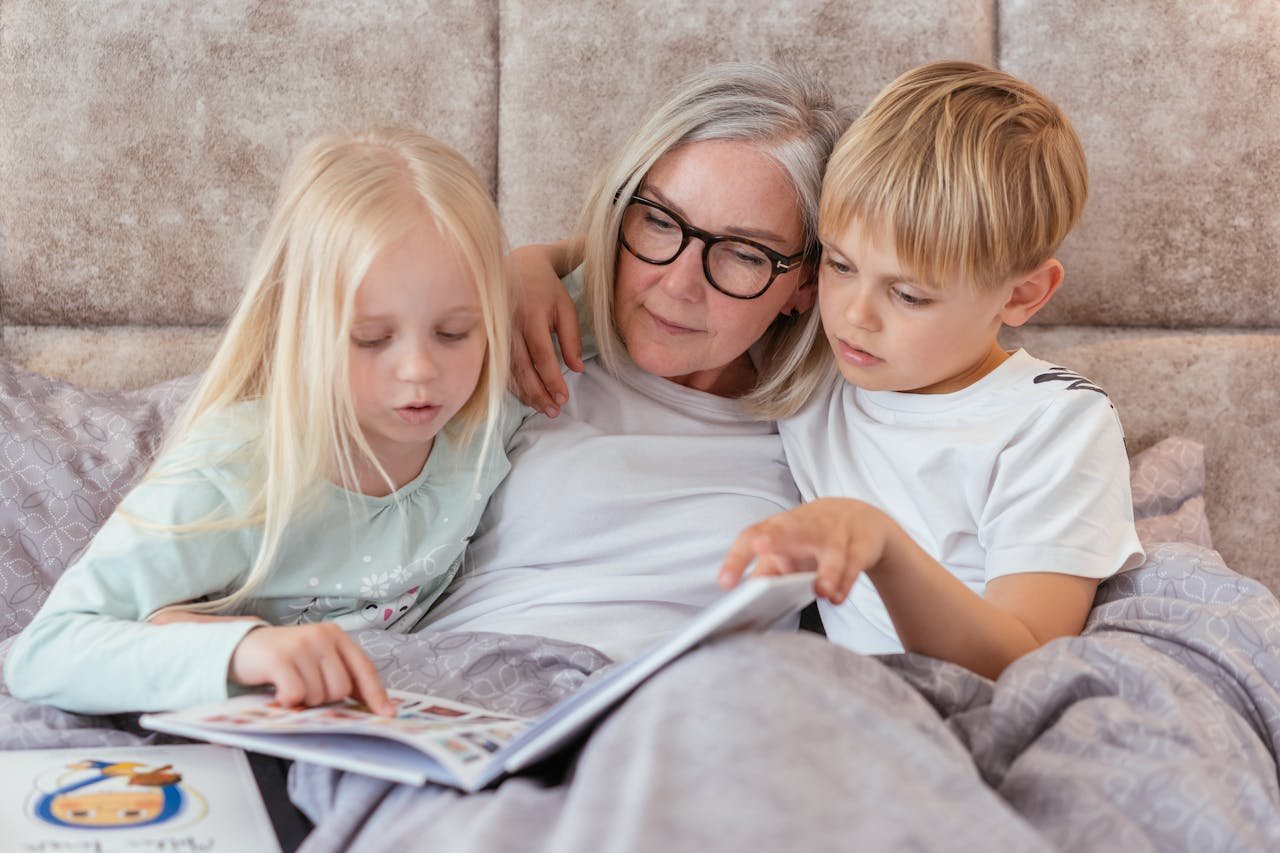 Grandmother reading to her young grandchildren.