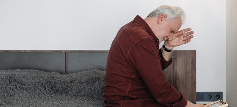 Stressed out older man worrying about how to protect a grandchild from a drug addicted parent.