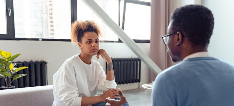 Two people having a serious conversation about holiday suicide awareness.