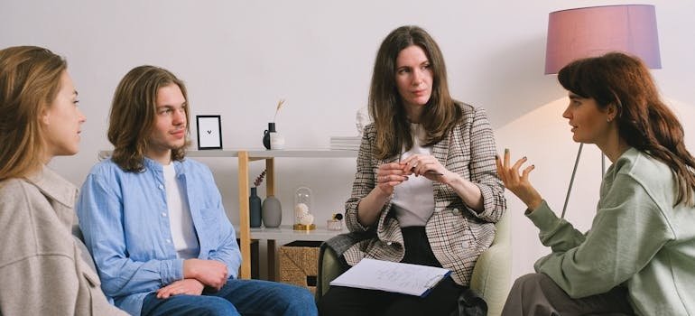 People in group therapy talking about how to prepare for rehab.