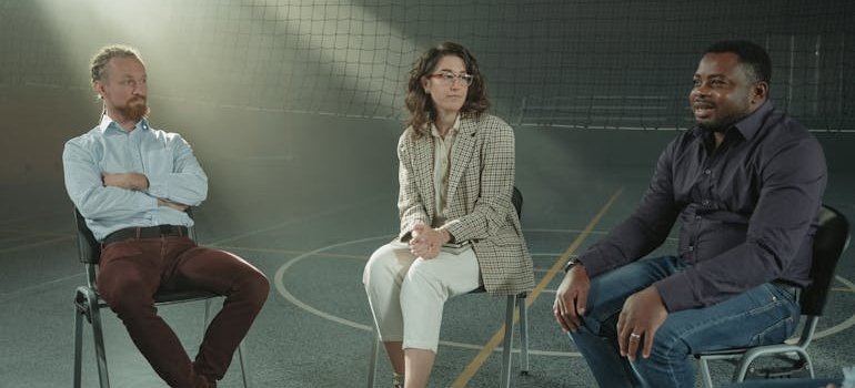 People in a peer support group sitting in a school gym.
