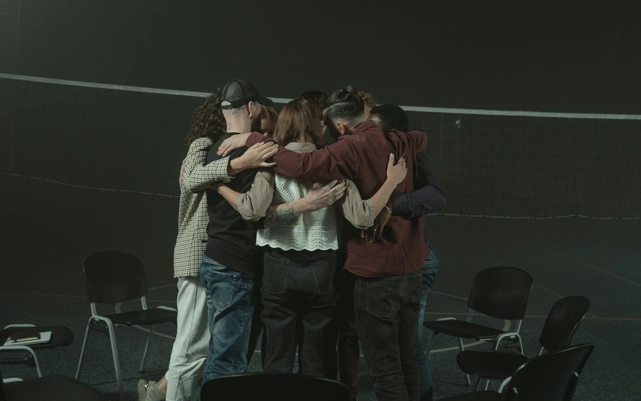 People in mental health support groups hugging each other.