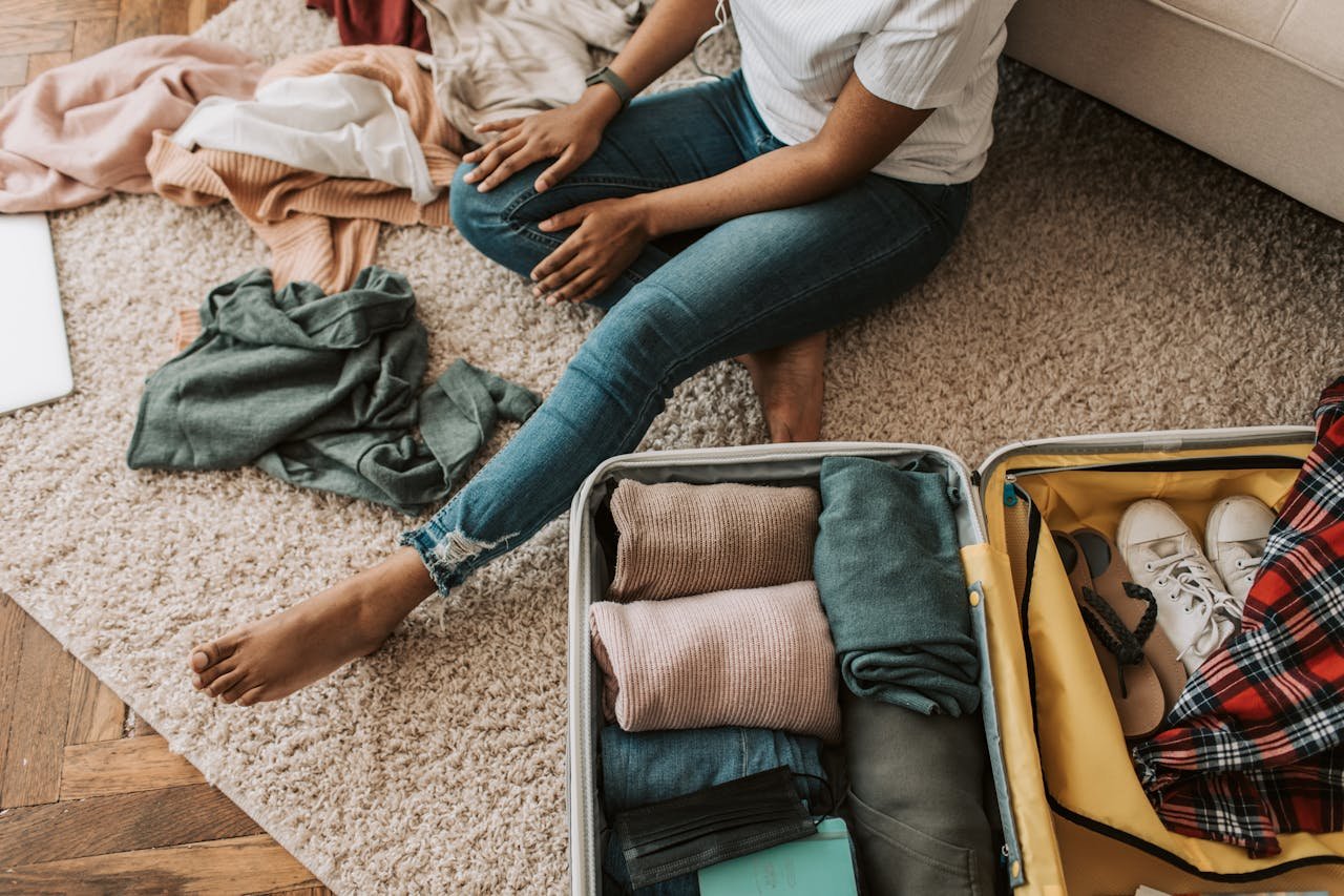 Woman packing a suitcase after learning how to prepare for rehab.