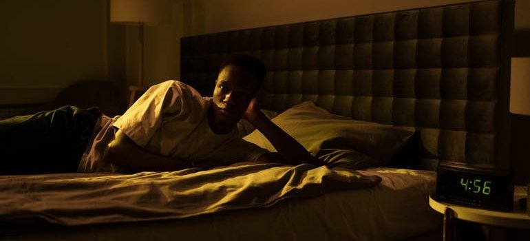 Man with insomnia lying on the bed.