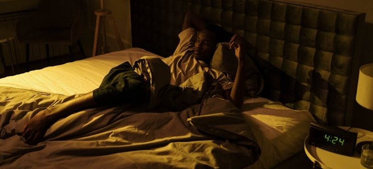 Man struggling with insomnia after mixing antidepressants and alcohol.