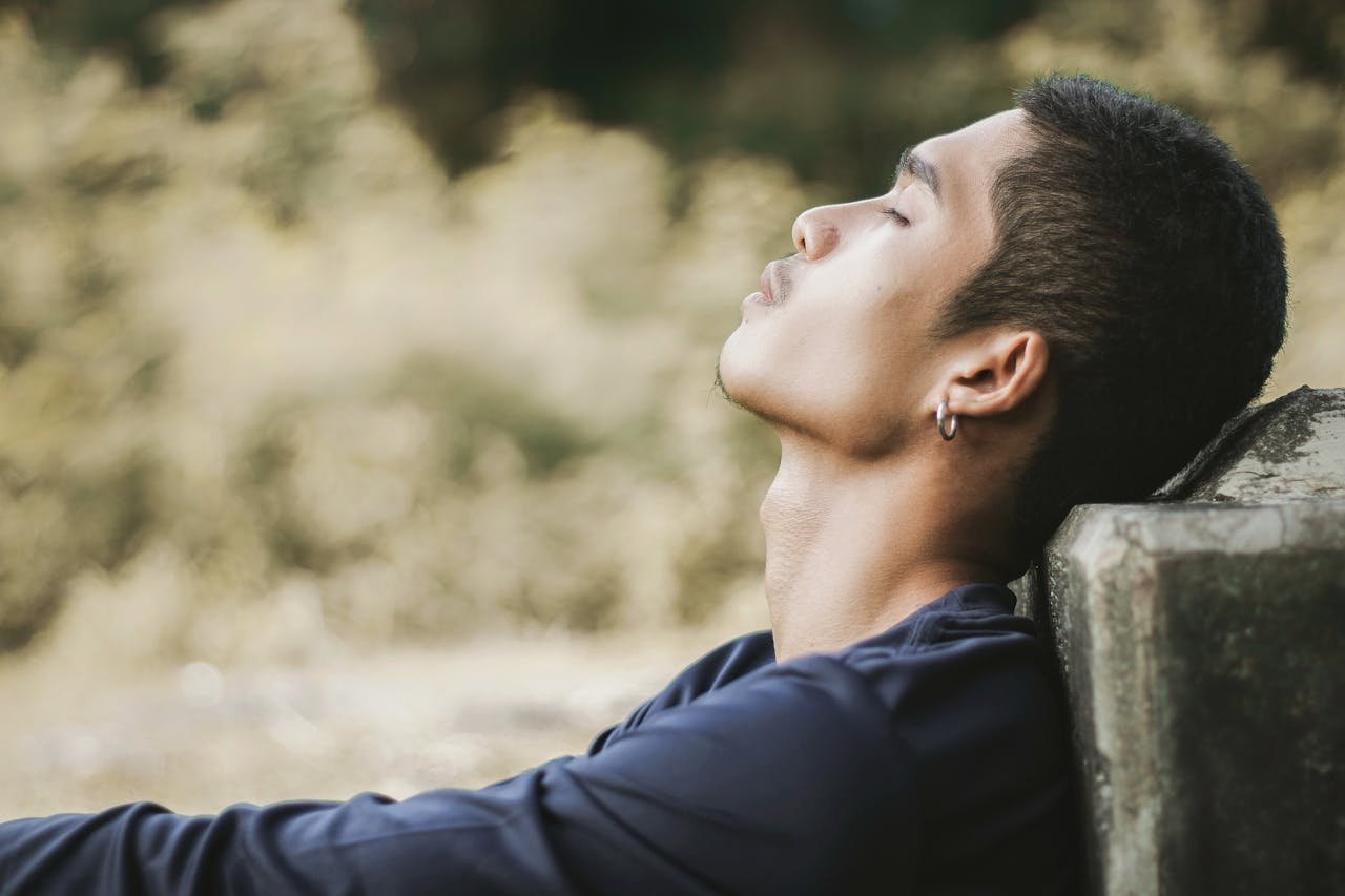 Man sitting on the floor and practicing calming techniques.