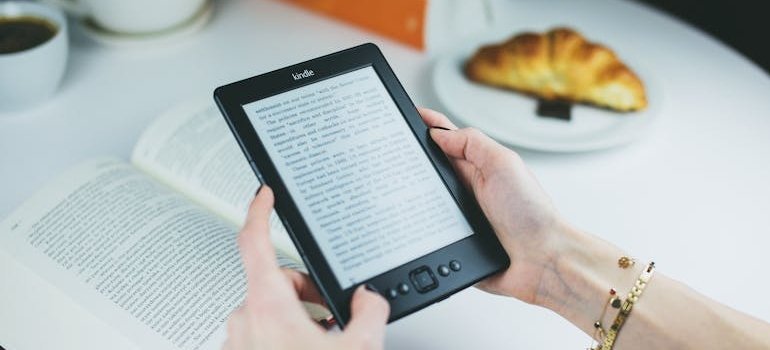 Person reading a book on an e-reader.