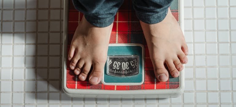 Man standing on a weight scale.