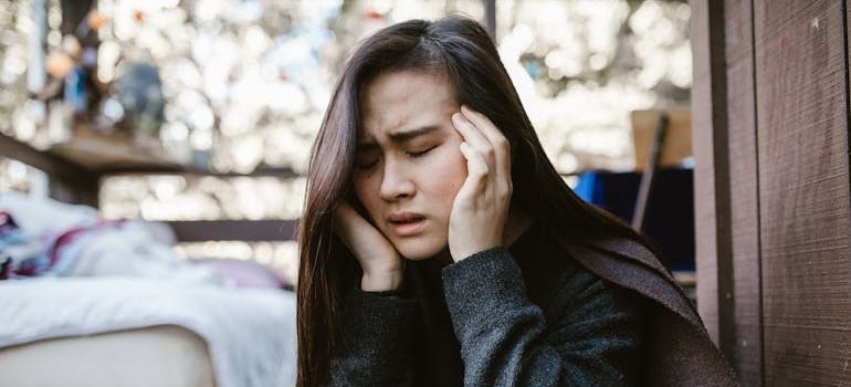 Woman holding her head while having a headache.