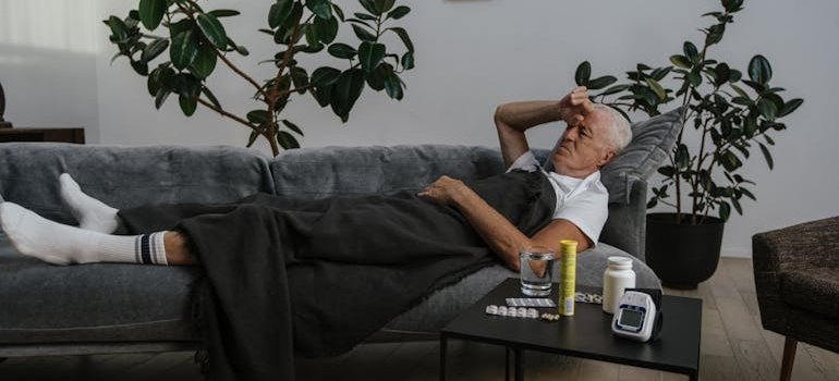 Sick man lying on his couch.