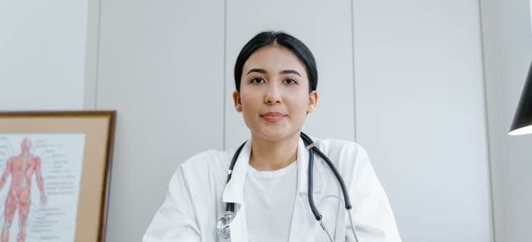 Doctor smiling and sitting at her desk.