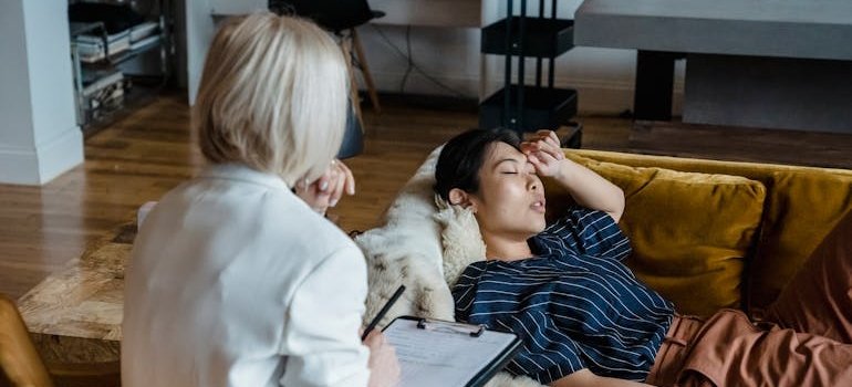 Woman lying on the couch and talking to a patient.