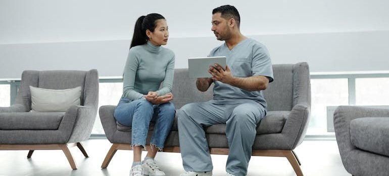 Nurse talking with a patient about methadone vs suboxone for opioid addiction treatment.