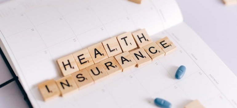 Health insurance spelled with letter blocks.