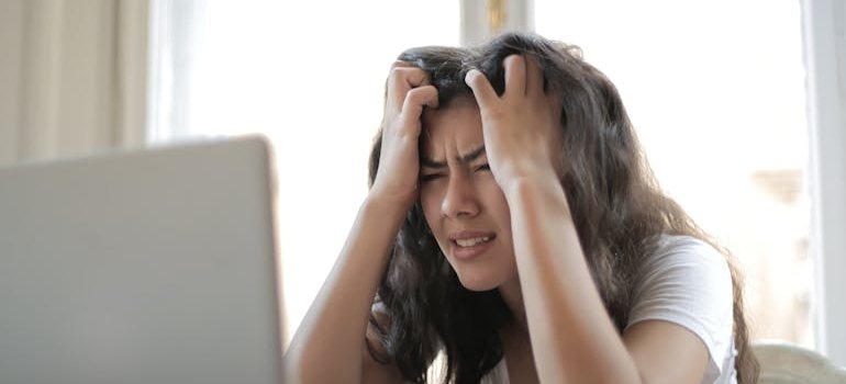 Stressed out woman looking at her laptop.
